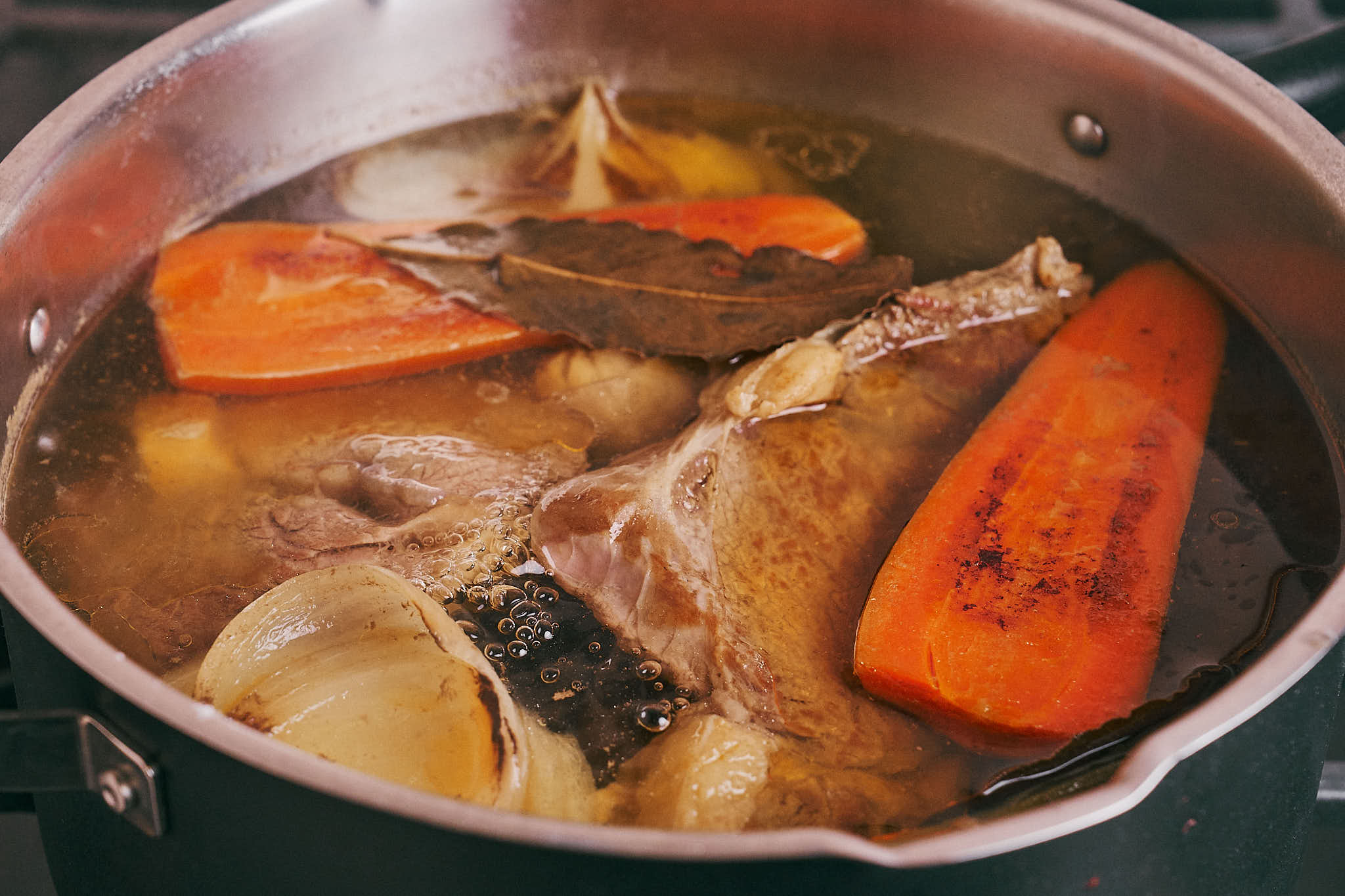 Beef and vegetables simmering in broth before removing from the pot