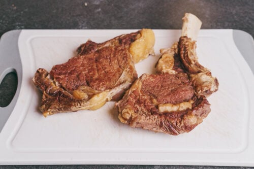 Cooked beef removed from the broth and ready to be cut