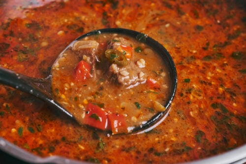 Hearty beef soup with walnuts simmering in the pot
