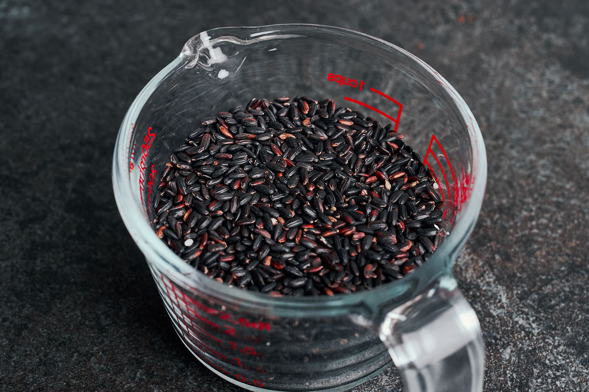 black rice measured in a cup before soaking