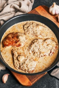 Creamy garlic chicken plated with tender chicken breast and rich garlic cream sauce