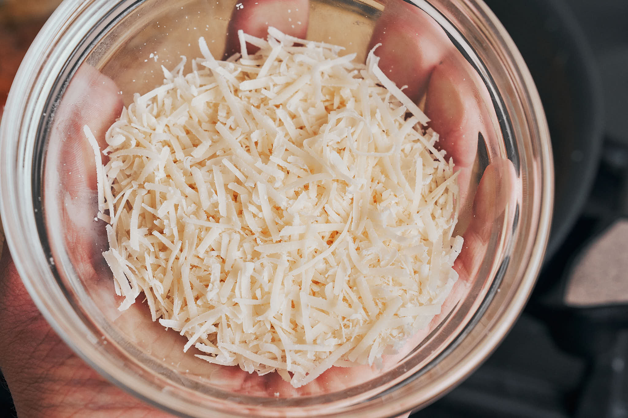 Freshly grated parmesan cheese ready to be added to the sauce