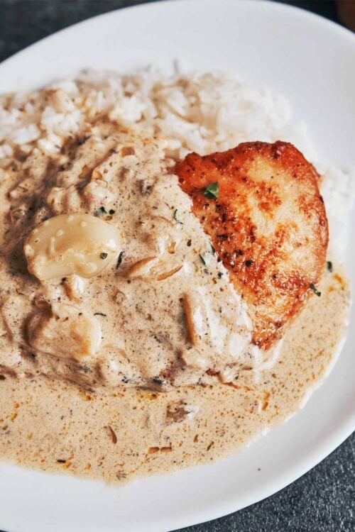 Creamy garlic chicken plated with sauce and tender chicken breast
