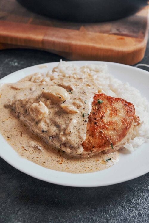 Creamy garlic chicken served on a plate with garlic cream sauce