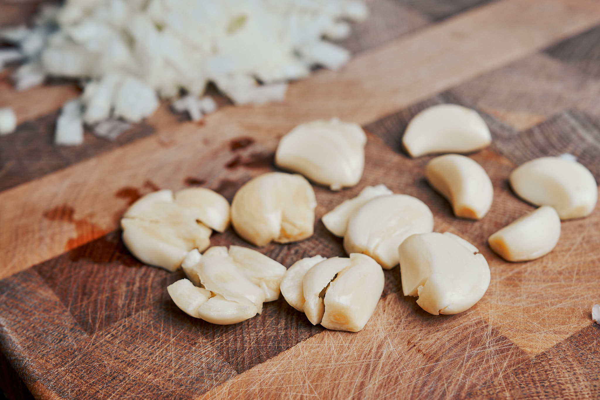 Smashed garlic cloves on a cutting board