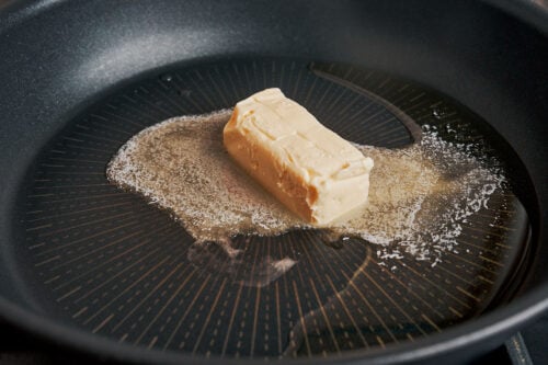 Butter melting in a skillet over medium heat