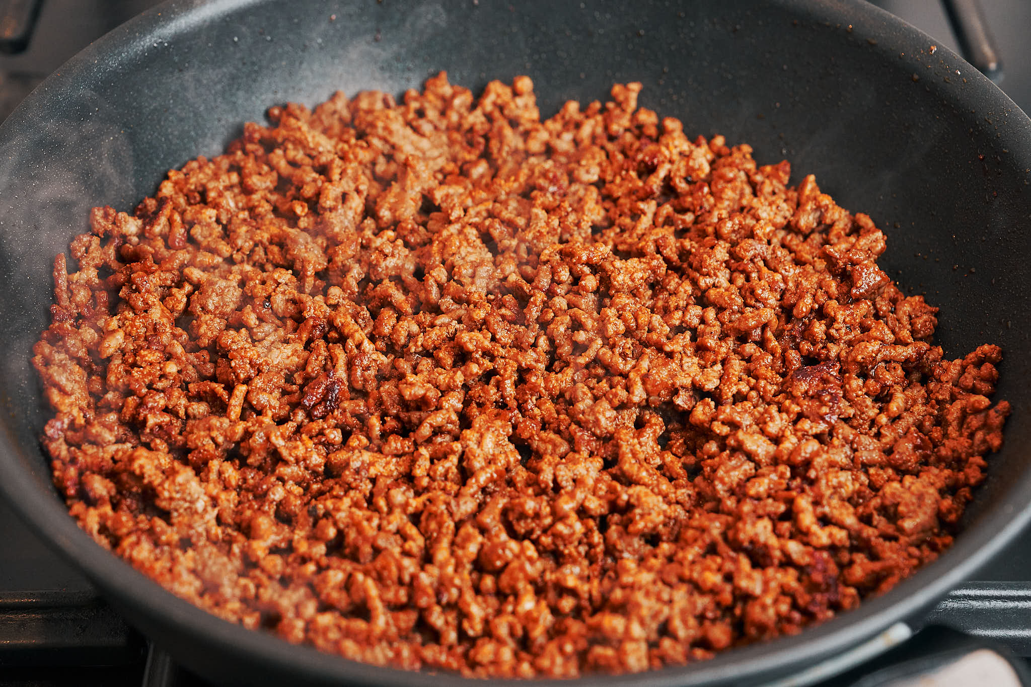Ground beef browned with seasonings in a skillet