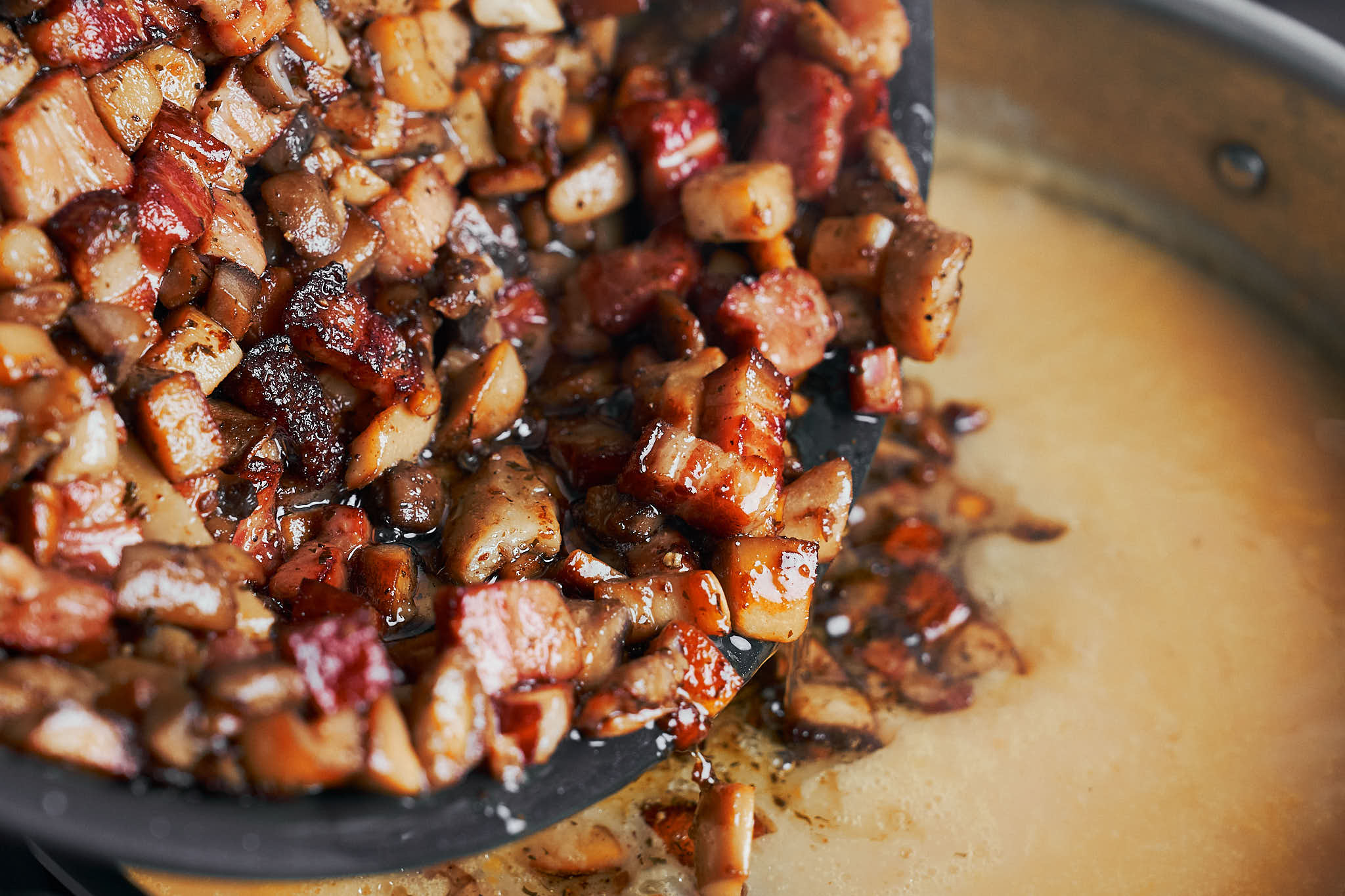 adding sautéed mushrooms and bacon to blended potato soup