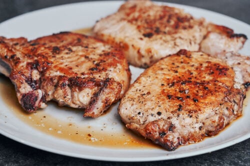 seared pork chops resting on a plate