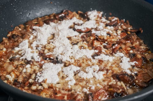 flour sprinkled over sautéed mushrooms and onions