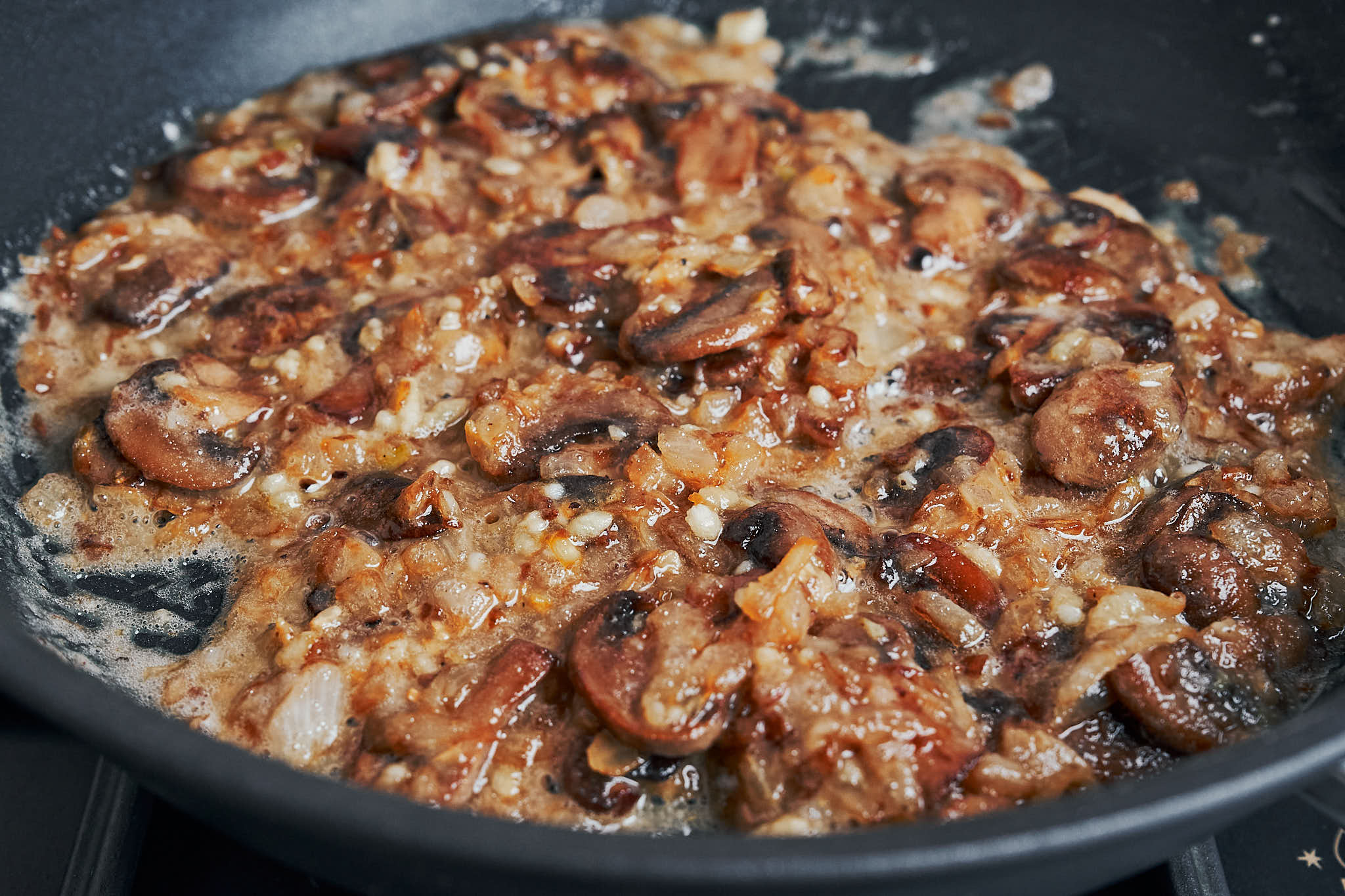 stirring flour into mushrooms and onions to thicken the sauce