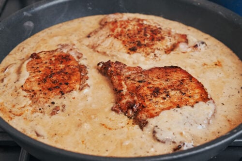 seared pork chops added to creamy mushroom sauce