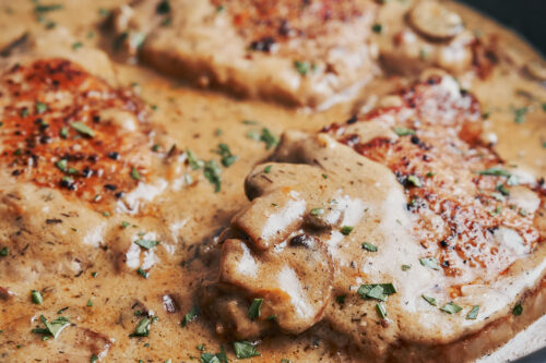 creamy mushroom pork chops garnished with parsley