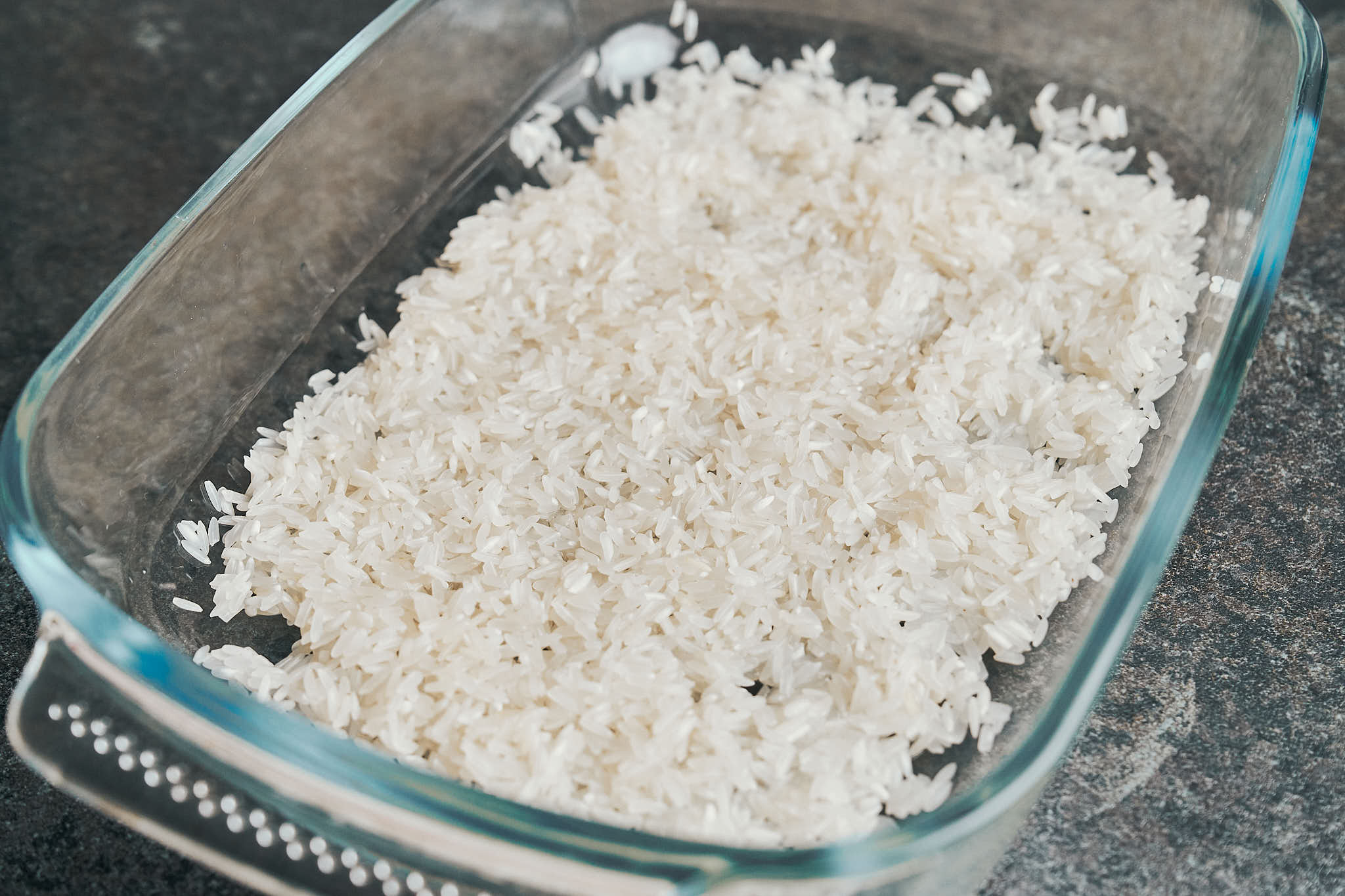 rinsed rice in a glass baking dish