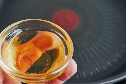 Sun-dried tomato oil in a small glass bowl
