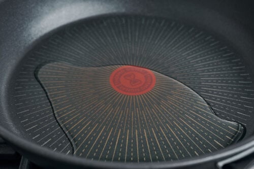 Olive oil heating in a large skillet