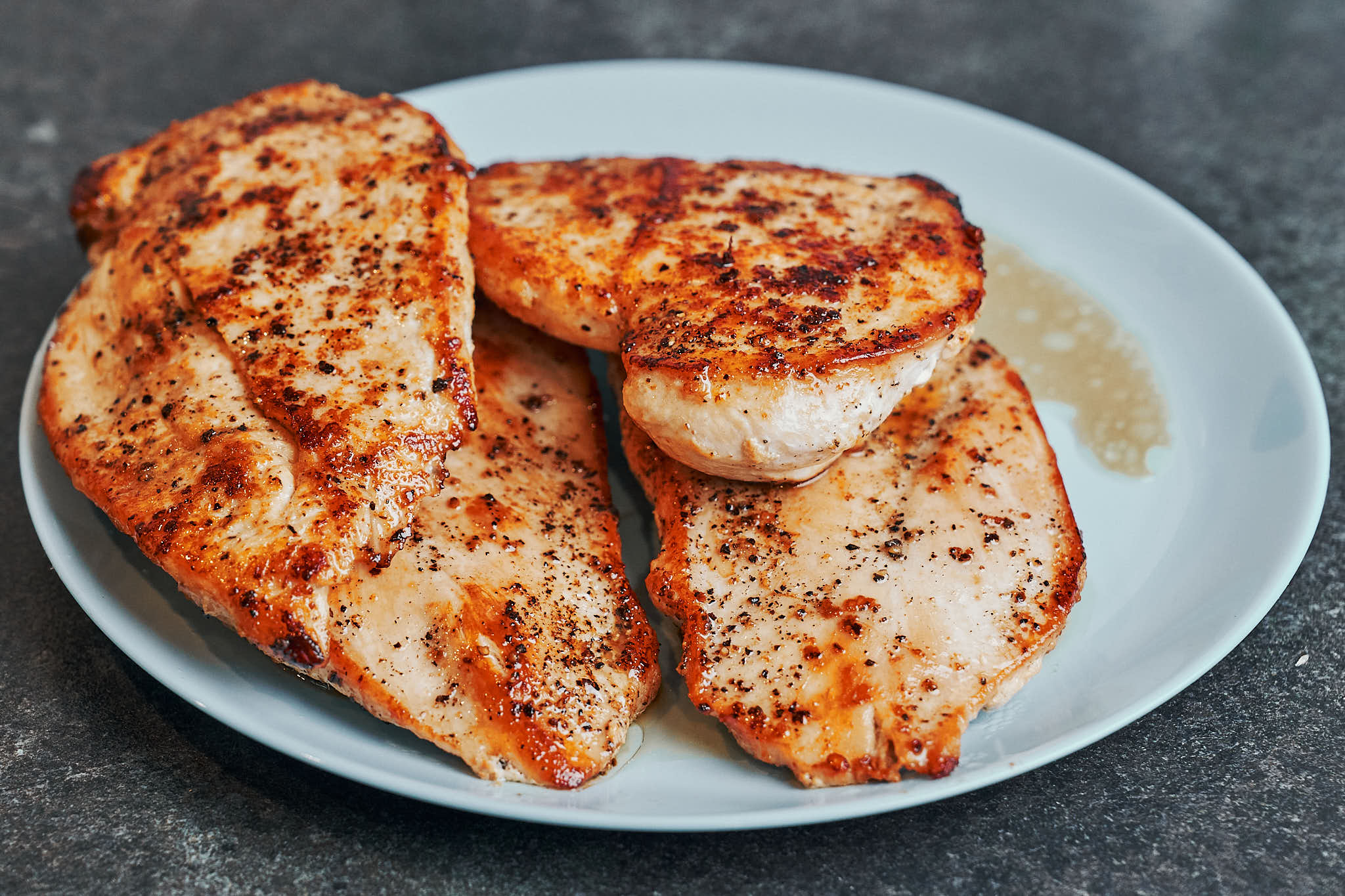 Pan-seared chicken cutlets resting on a plate