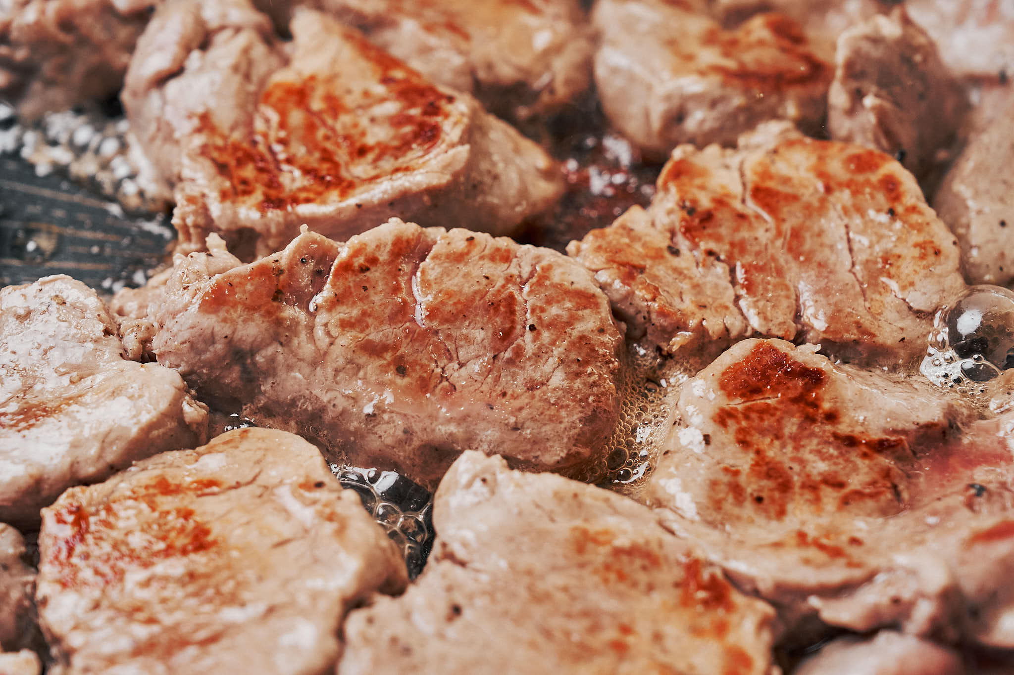 seared pork tenderloin medallions in a skillet