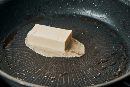 butter melting in a skillet after searing pork