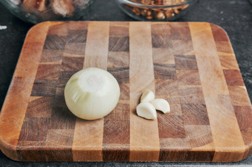 onion and garlic on a cutting board