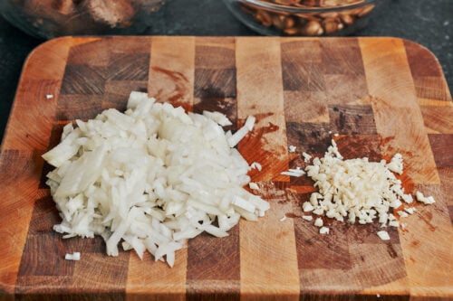 chopped onion and minced garlic on a cutting board