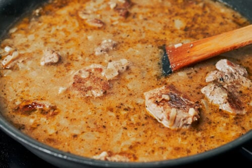 pork tenderloin medallions simmering in creamy cognac sauce