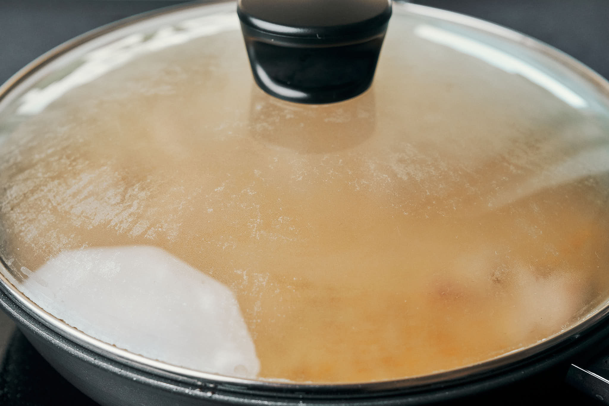 pork tenderloin medallions gently simmering under a lid
