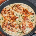 golden creamy parmesan chicken with rice and homemade parmesan sauce