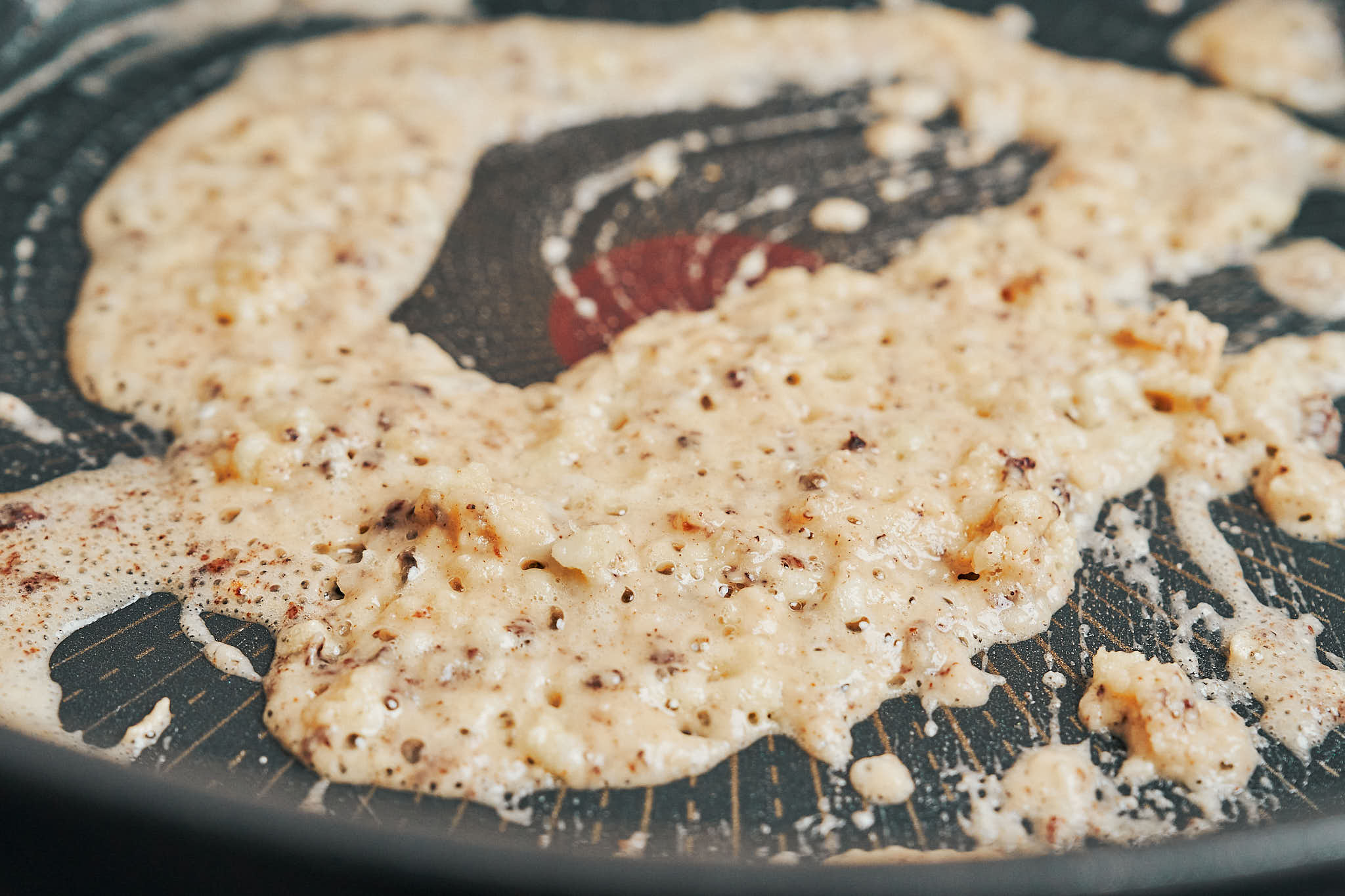 flour and garlic cooking together in the skillet to create a creamy sauce base