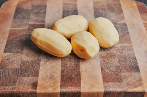 peeled potatoes ready to be diced for this cozy skillet dinner