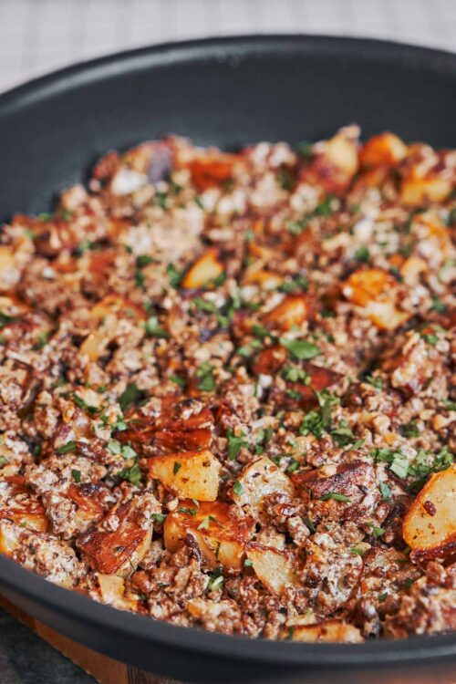 finished ground beef and potatoes skillet with fresh parsley