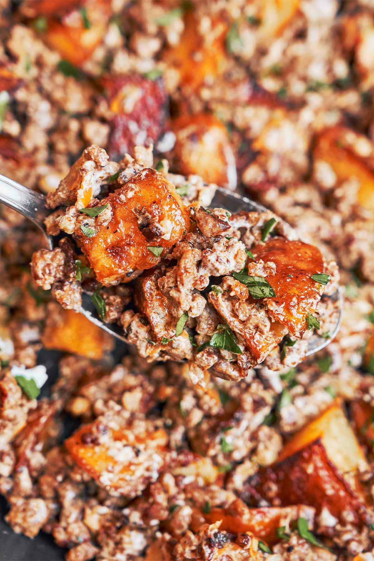 spoonful of creamy ground beef and crispy potatoes fresh from the skillet