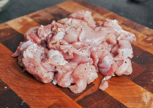 seasoned diced chicken thighs ready for cooking