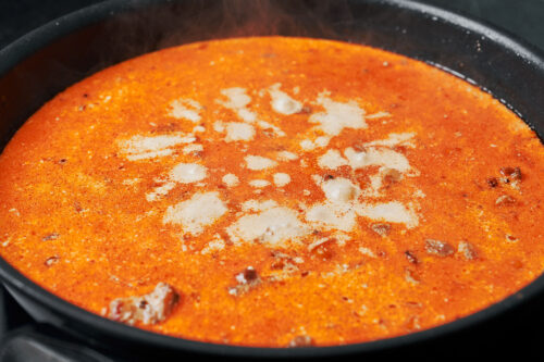 creamy chicken and rice simmering in a skillet