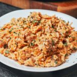 one pot creamy chicken and rice served in a plate with parmesan and herbs
