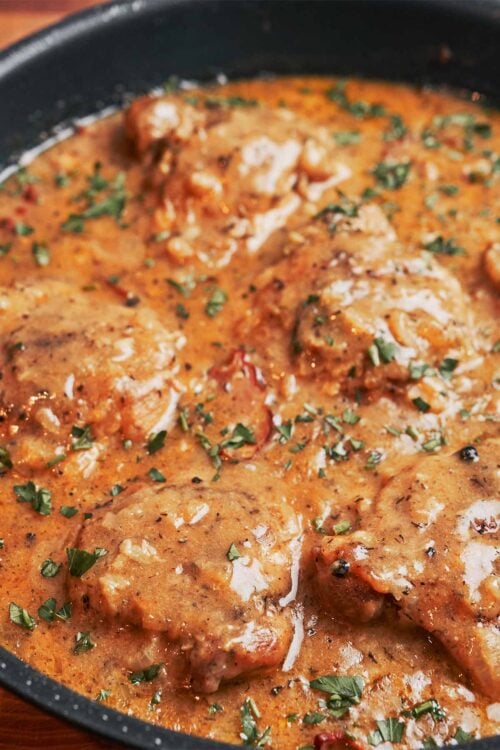 creamy chicken thighs with bacon in skillet