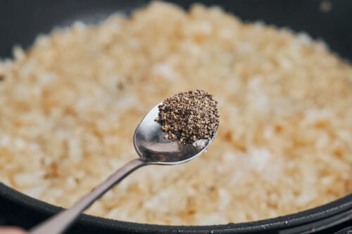 black pepper added to onions in skillet