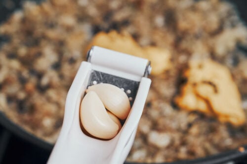 garlic pressed into onion mixture in skillet