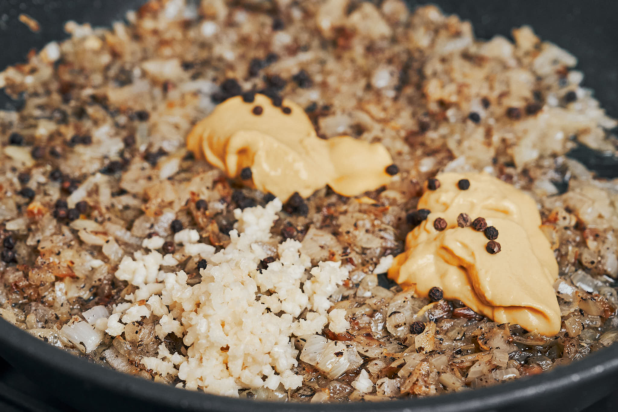 creamy sauce base with garlic Dijon mustard and onions in skillet