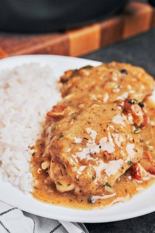 creamy chicken thighs with bacon served over rice