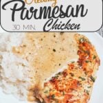 Creamy parmesan chicken in a skillet with golden seared chicken breasts covered in rich garlic parmesan cream sauce