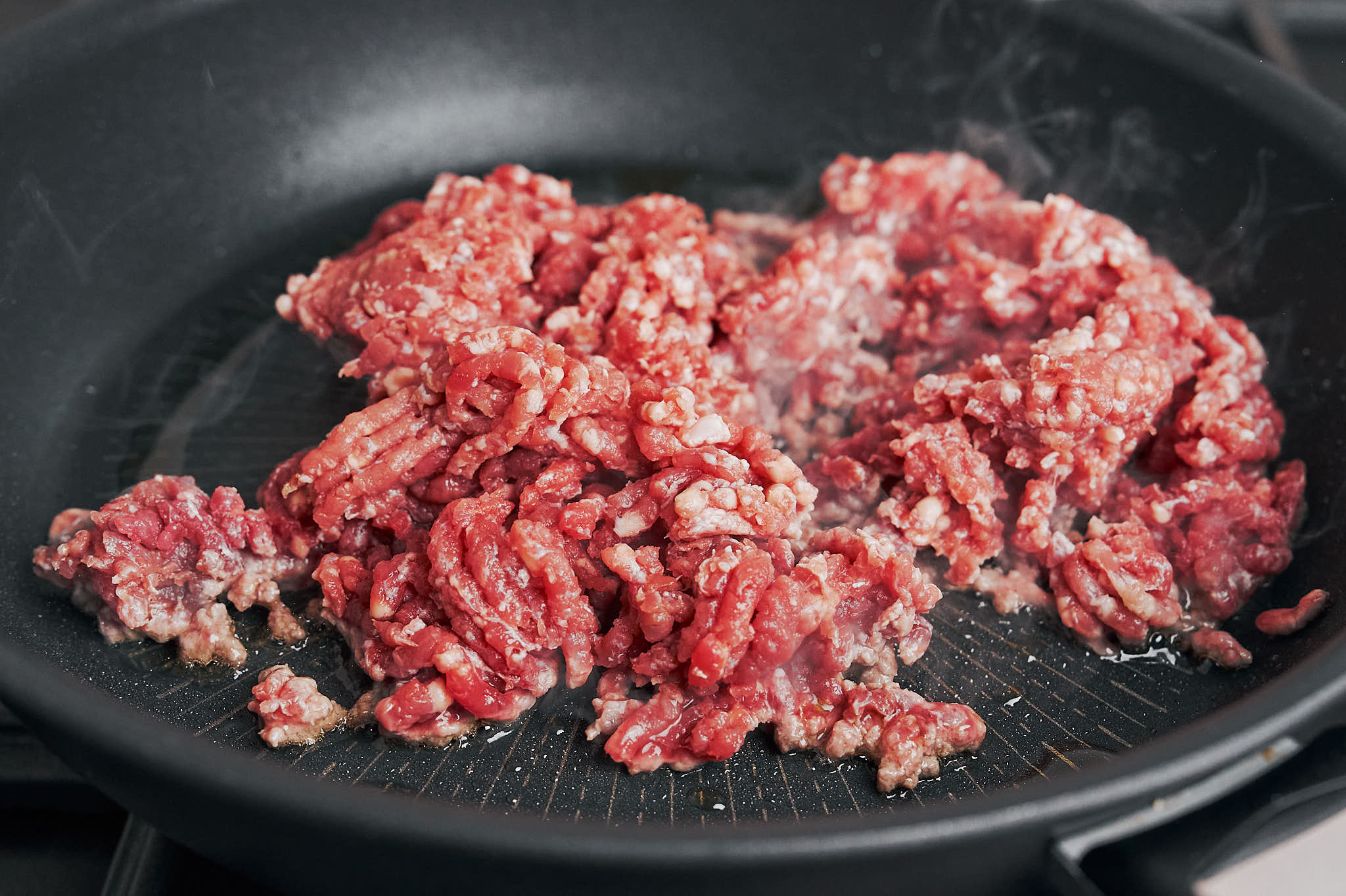 browned ground beef in skillet ready for stroganoff