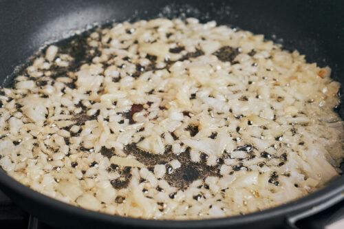diced onion sautéing in butter in skillet