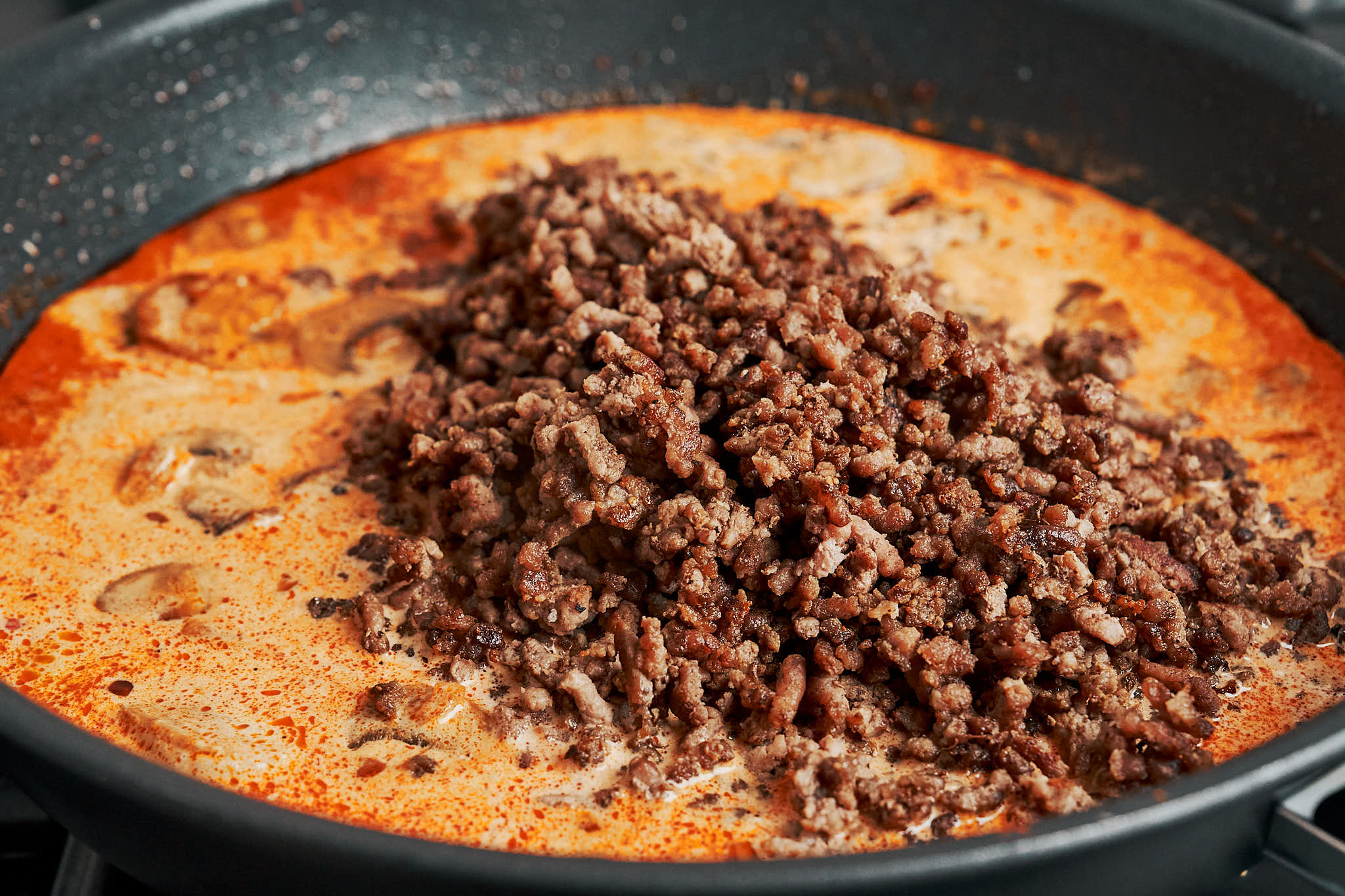 browned ground beef added back into the creamy sauce