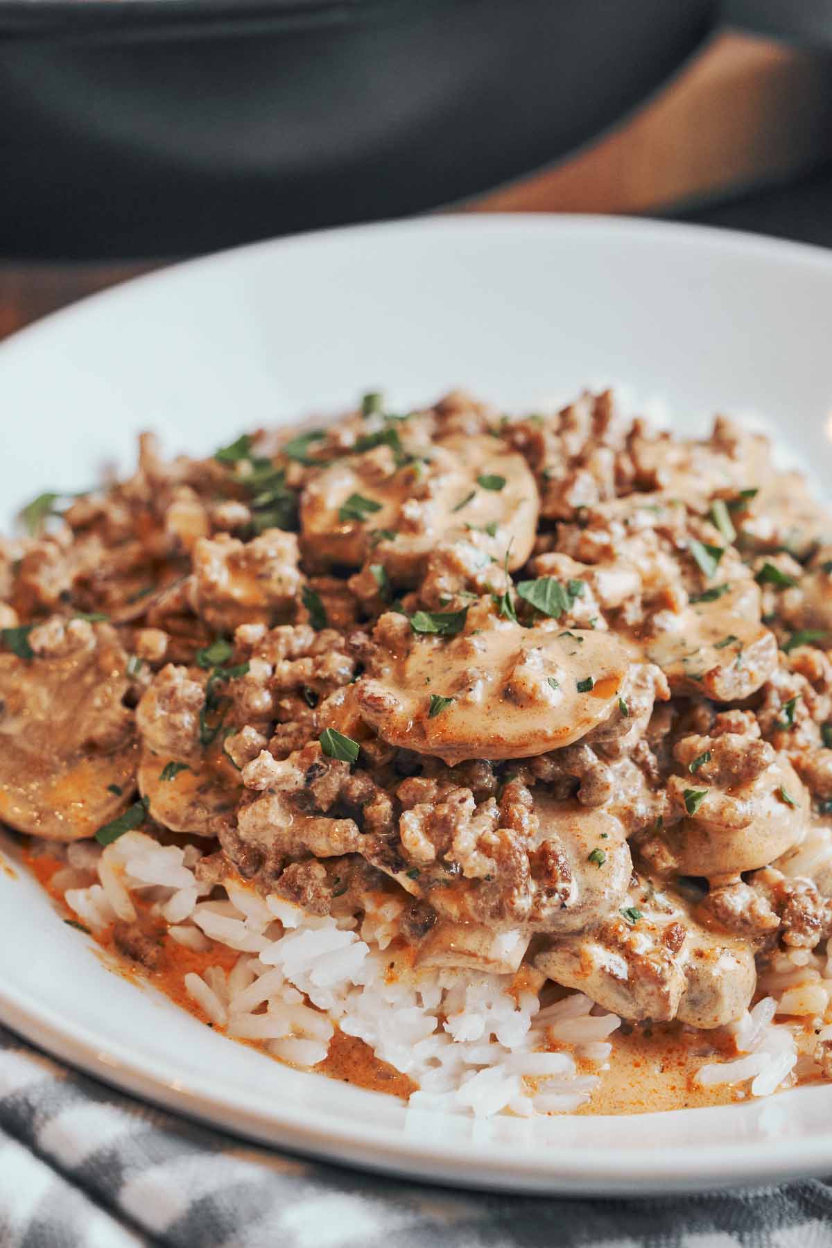 creamy ground beef stroganoff with mushrooms served over rice
