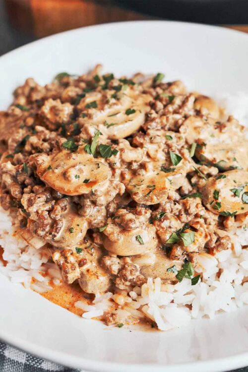 creamy ground beef stroganoff with mushrooms served over rice