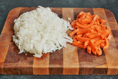 chopped onions and sliced carrots for hearty pork stew