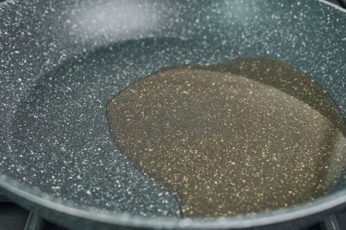 oil heating in skillet before sautéing vegetables