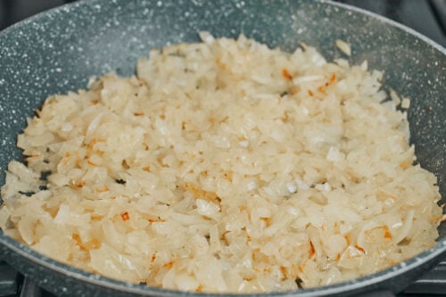 onions sautéing in pan until soft and lightly golden