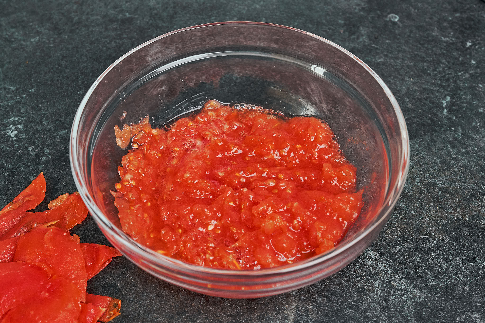 fresh grated tomatoes in glass bowl for pork stew